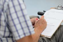 Man sitting and completing a survey