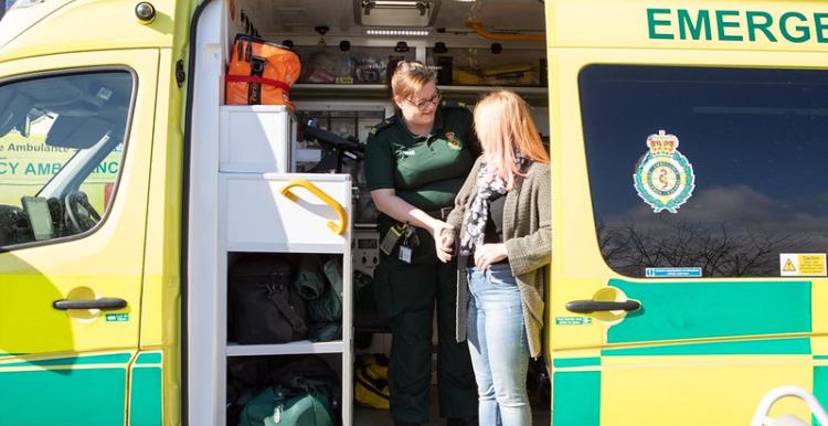 Lady being helped out of an ambulance