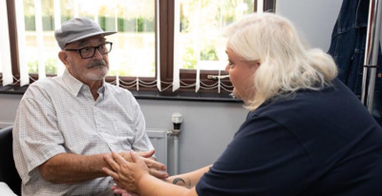 lady talking to a elderly man
