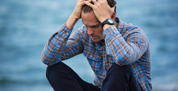 Man sat with his head in his hands