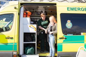 Lady being helped out of an ambulance