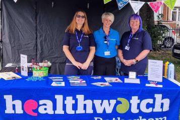 Healthwatch Rotherham staff standing by their stall