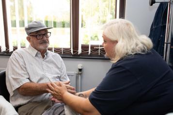 lady talking to a elderly man