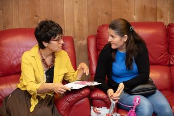 Two women sat on chairs talking