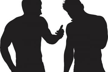 silhouette of two men talking