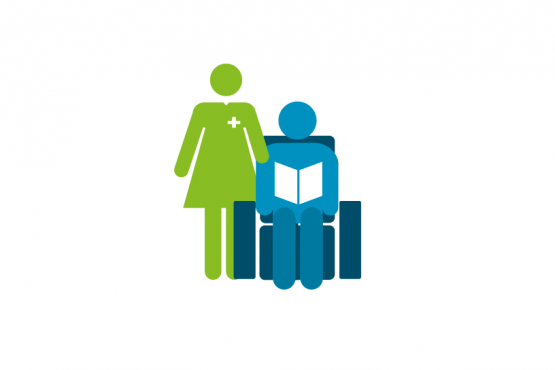 Person sitting on chair reading with nurse behind Person sitting on chair reading with nurse behind
