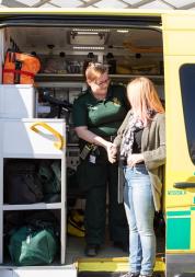 Lady being helped out of an ambulance