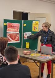 Leiann pointing to a picture showing tooth decay